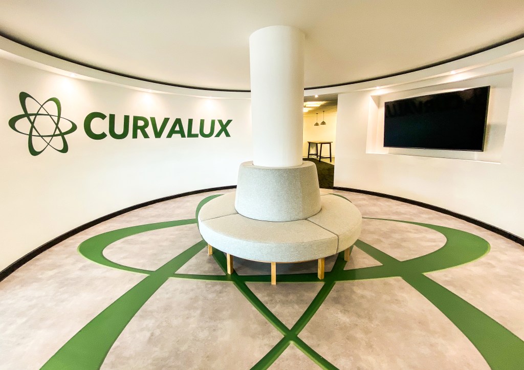 Curvalux office reception with a round seat around a white pillar