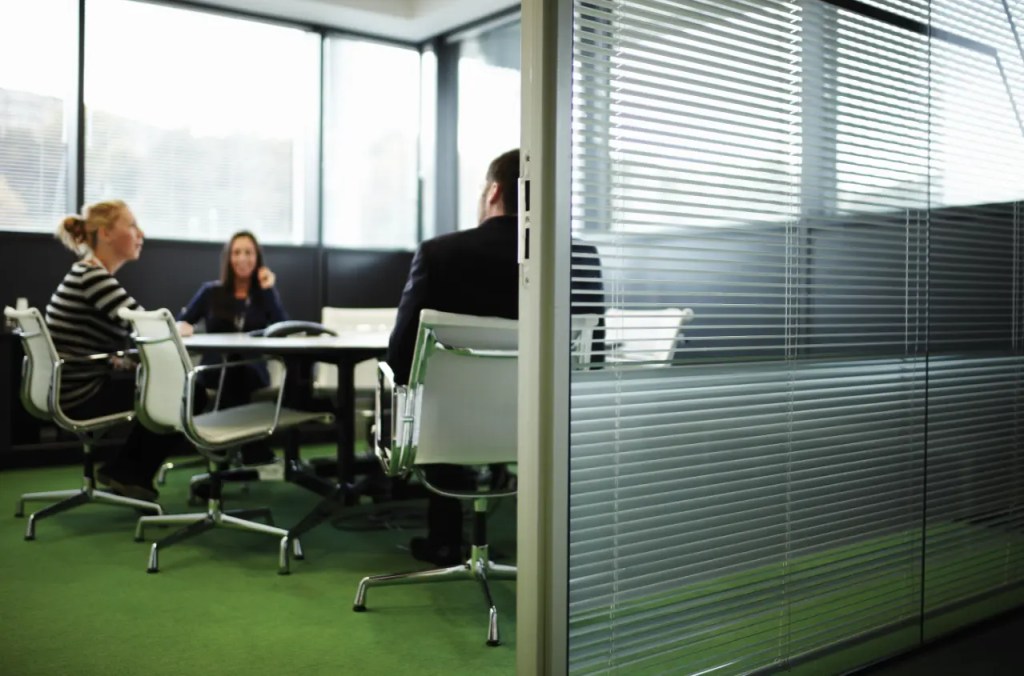 A team meeting in one of the green meeting rooms at Electric Works