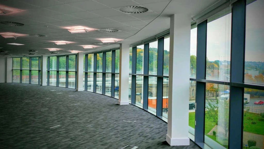 Spacious office with full-height windows and views across Sheffield